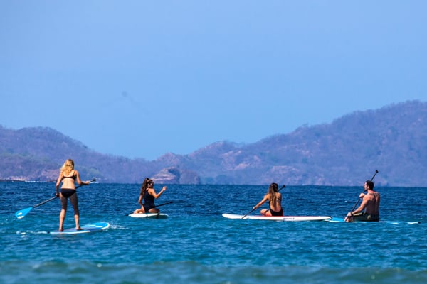 Stand-up paddling out to the yoga platform in the ocean